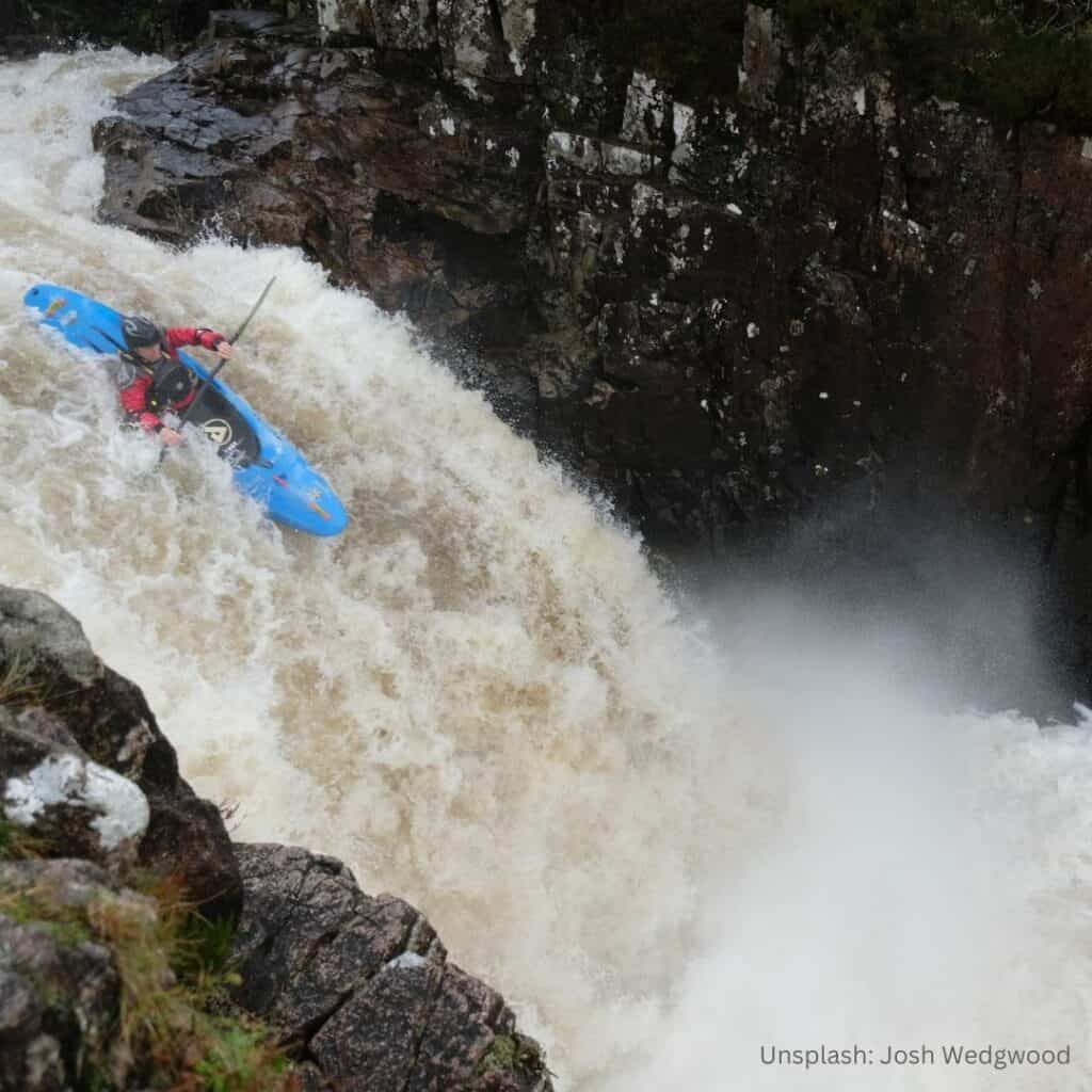 Whitewater kayak going over small falls